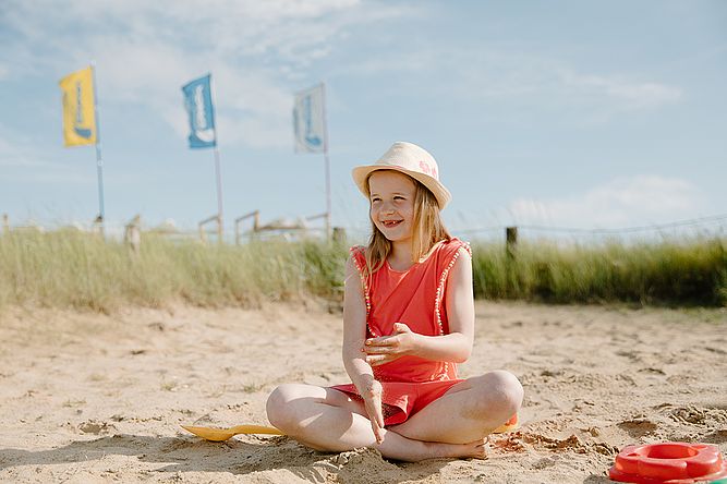Junges Mädchen spiel im Sand der Lagune in Büsum 